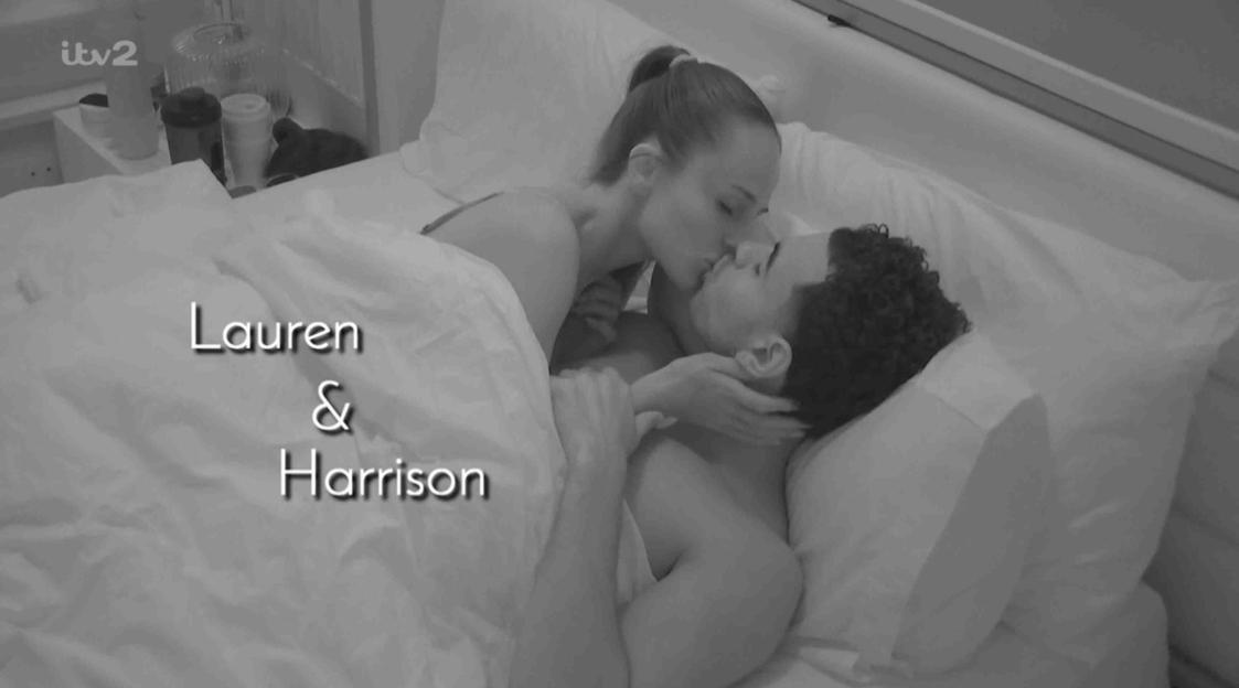 Lauren and Harrison kissing in bed.