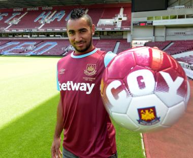Dimitri Payet in West Ham United jersey holding a soccer ball at Upton Park.