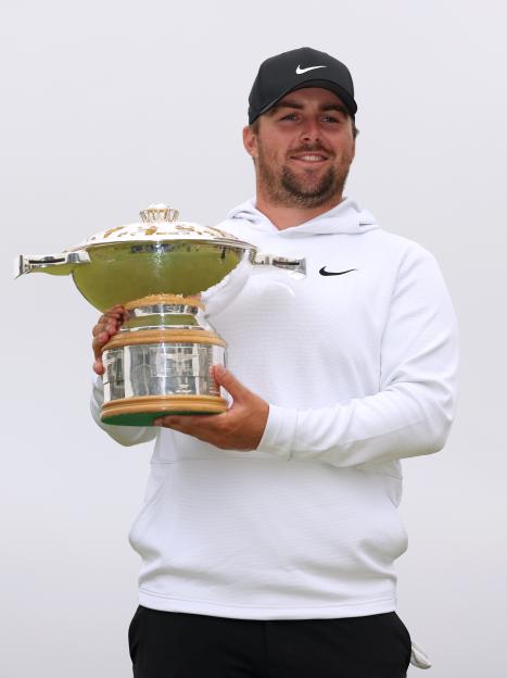Chris Gotterup holding the Genesis Scottish Open trophy.