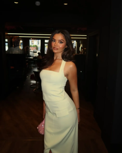 Woman in a pale yellow dress in a restaurant.