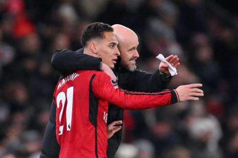 Manchester United's Antony receiving instructions from manager Erik ten Hag.