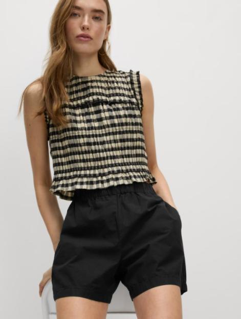 Model wearing black poplin shorts and a gingham sleeveless top.