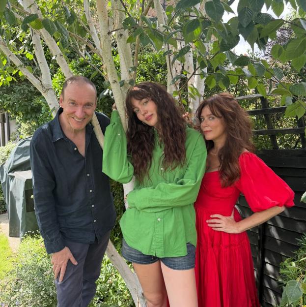 Anna Friel, David Thewlis, and their daughter Gracie Friel posing together outdoors.