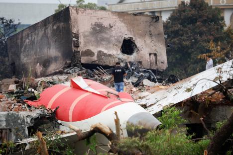 A fire officer surveys the wreckage of a crashed Air India Boeing 787-8 Dreamliner.