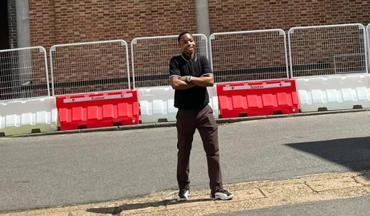 Person standing in front of a large collage celebrating 100 years of Elstree Studios.