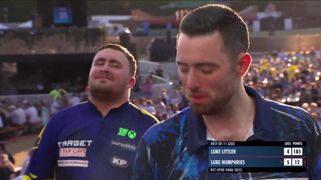 Luke Humphries and Luke Littler during a darts match.