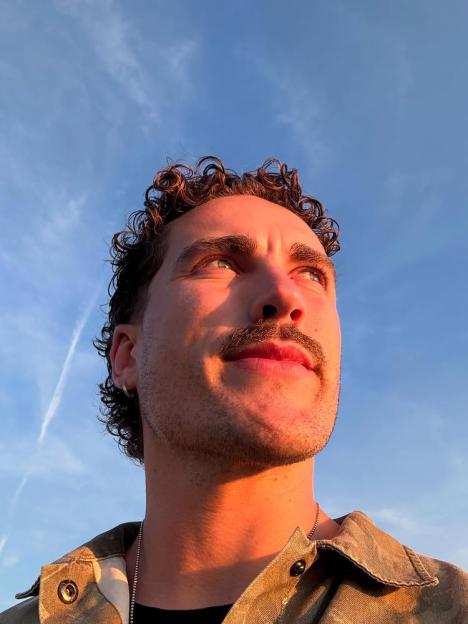 Man looking up at sunset.