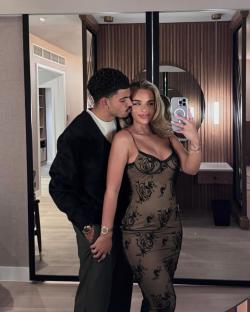 Couple taking a selfie in a hotel room.