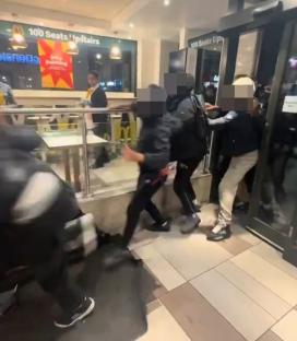 A McDonald's employee slapping a customer during a brawl.