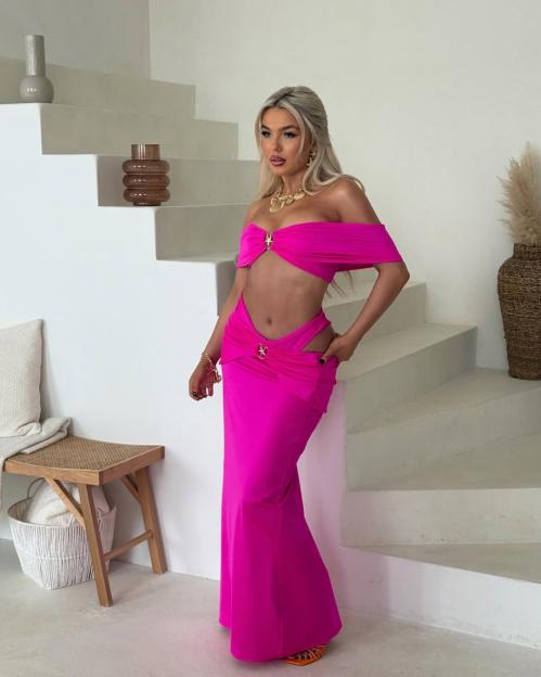 Lucy Quinn, Love Island contestant, in a hot pink swimsuit and maxi skirt.