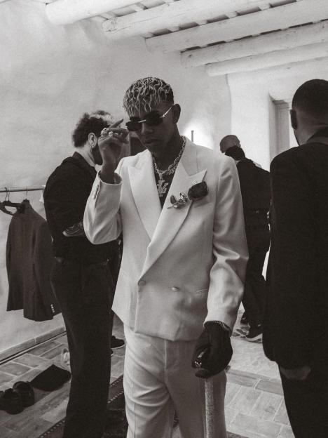 Black and white photo of Lamine Yamal in a white suit.