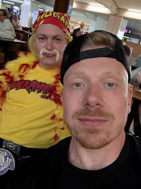 Photo of two men, one dressed as Hulk Hogan.