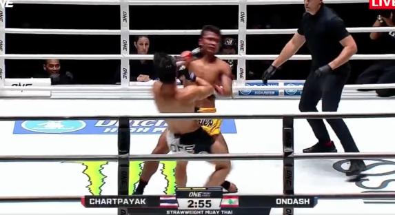 Two Muay Thai fighters exchanging blows in a ring.
