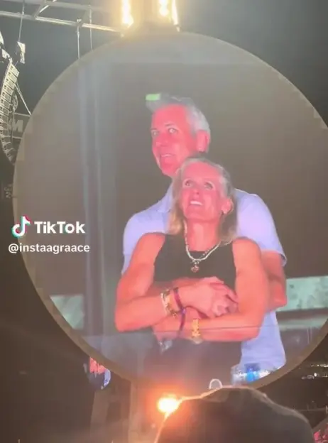 Image of a couple embracing, projected onto a large circular screen.