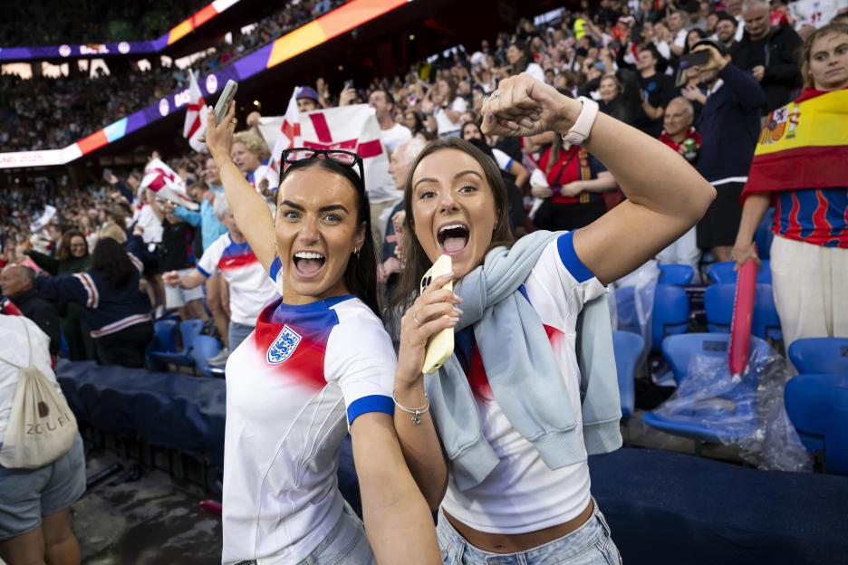Two ecstatic England soccer fans celebrating a victory.