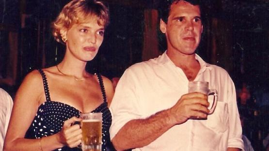 Photo of Annette Herfkens, the sole survivor of a 1992 Vietnam Airlines plane crash, with a man, both holding beers.