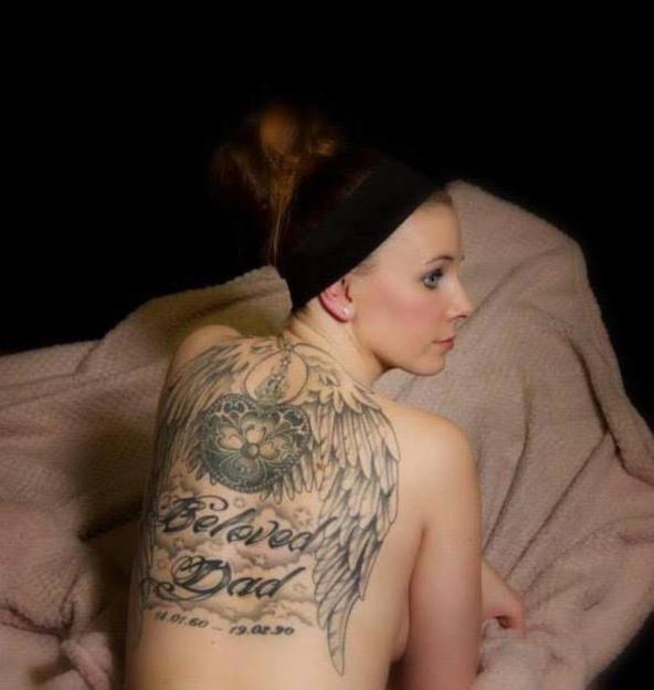 Woman with a large back tattoo that says