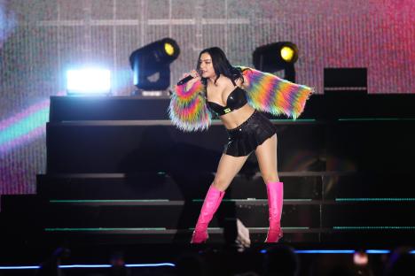 Charli XCX performing live at a concert.