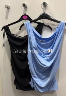 Close-up of a light blue Primark top with gold clasp.