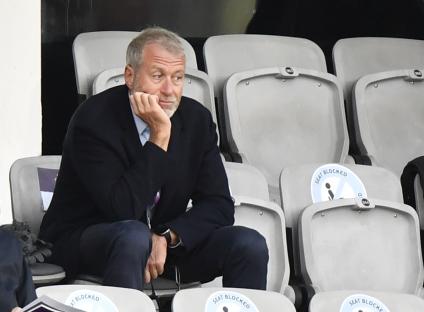 Roman Abramovich sitting in stadium seats.