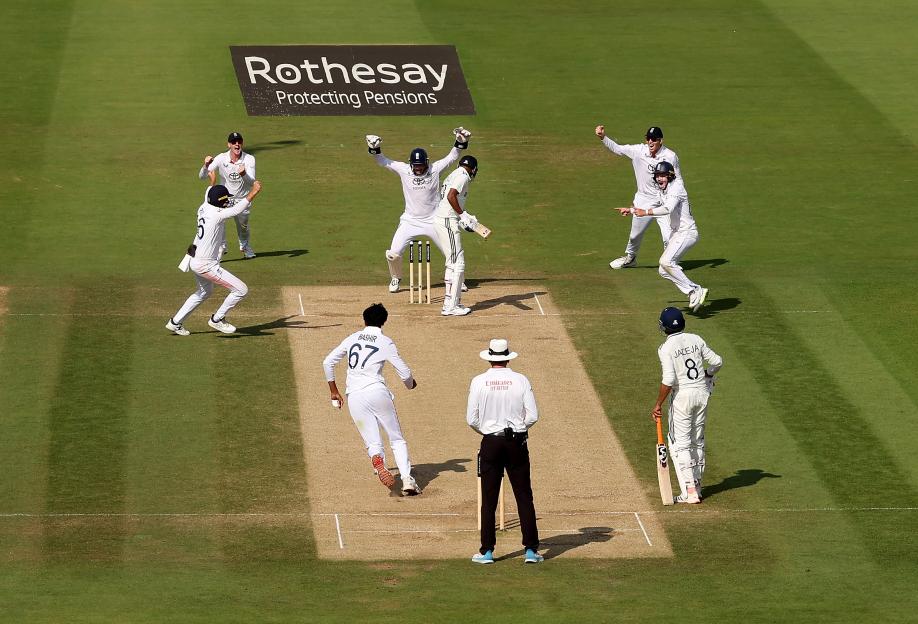 England cricket team celebrating a wicket at Lord's Cricket Ground.