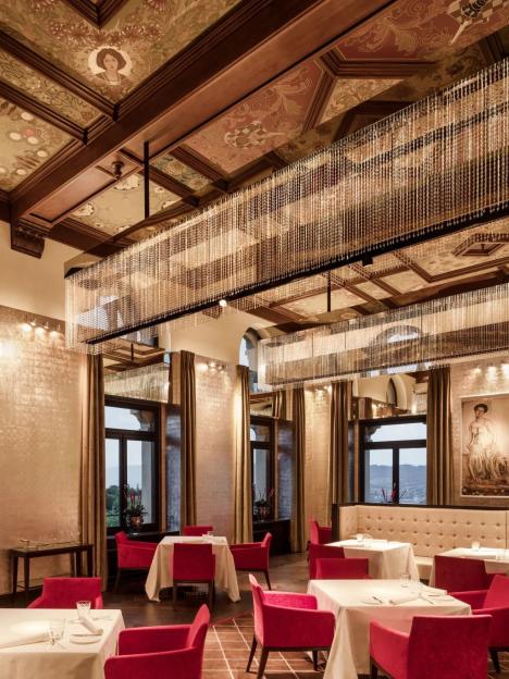 Upscale restaurant dining room with crystal chandeliers.