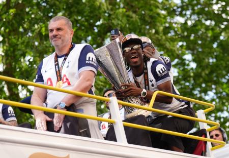 Tottenham Hotspur's Yves Bissouma and manager manager Ange Postecoglou with the trophy on the open-top team bus during the Europa League winners parade in North London. Tottenham won the Europa League final after beating Manchester United 1-0 in Bilbao on Wednesday. Picture date: Friday May 23, 2025. PA Photo. See PA story SOCCER Tottenham. Photo credit should read: John Walton/PA Wire. RESTRICTIONS: Use subject to restrictions. Editorial use only, no commercial use without prior consent from rights holder.