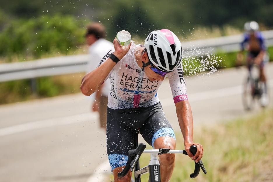 Cyclist Samuele Privitera pouring water over himself during the 7th stage of the Giro Next Gen 2024.