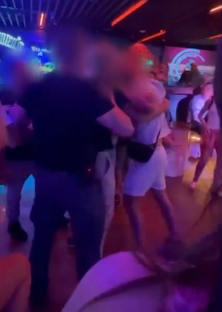 Security breaking up a fight in a nightclub.