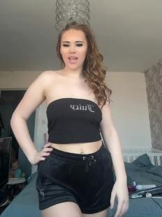 Woman in black Juicy Couture top and shorts.