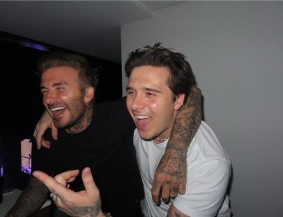David and Brooklyn Beckham laughing together.