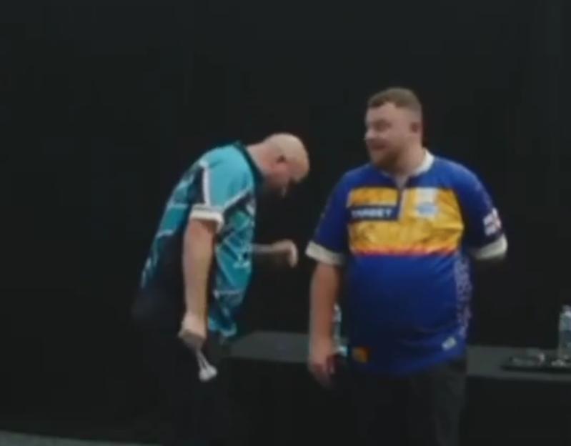 Two men in darts jerseys.