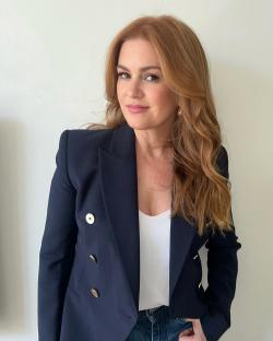 Isla Fisher in a navy blazer.