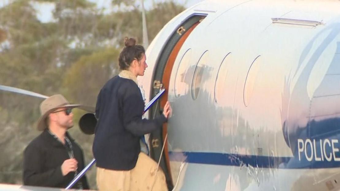 Carolina Wilga boarding a plane after being found safe.