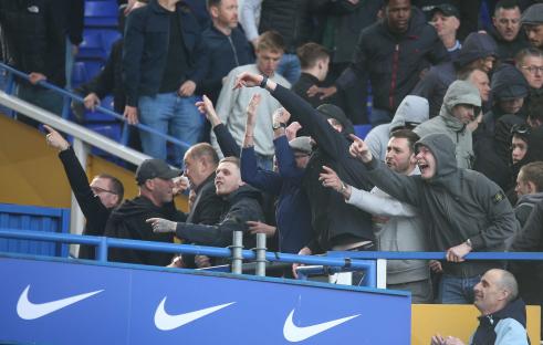 Millwall fans celebrating at a Birmingham City vs. Millwall soccer match.