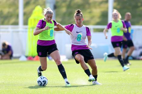 Alessia Russo and Maya Le Tissier of England's women's national team battling for the ball during a training session.