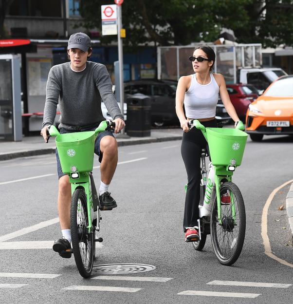 Olivia Rodrigo and Louis Partridge riding Lime bikes.