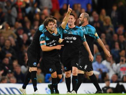 Soccer Aid World XI players celebrating a goal.