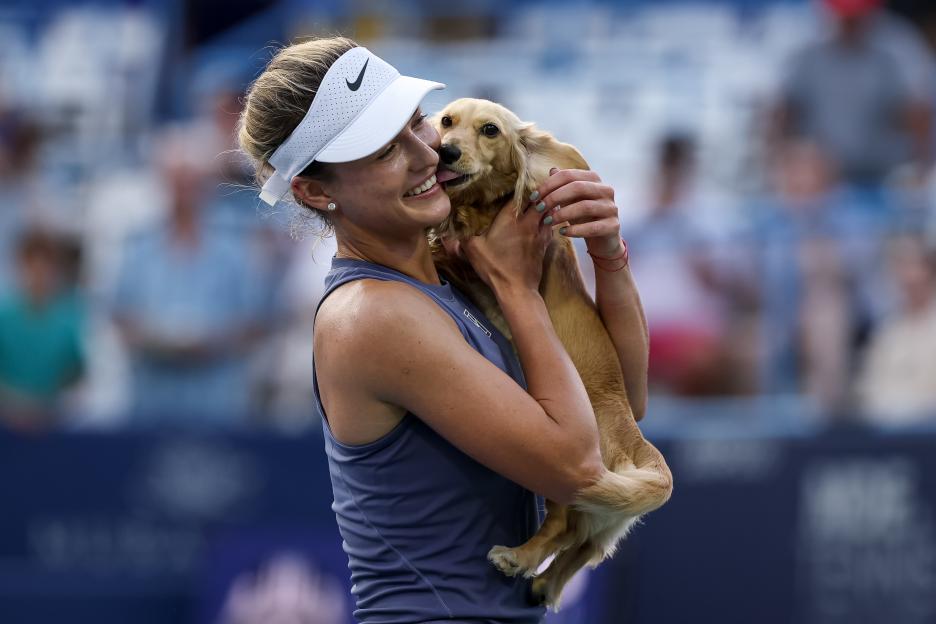 Tennis player Anna Kalinskaya celebrates her win with her dog.