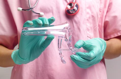 Gynecologist holding a vaginal speculum.