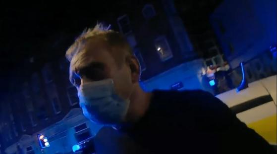 Graham Head, wearing a facemask, at night.