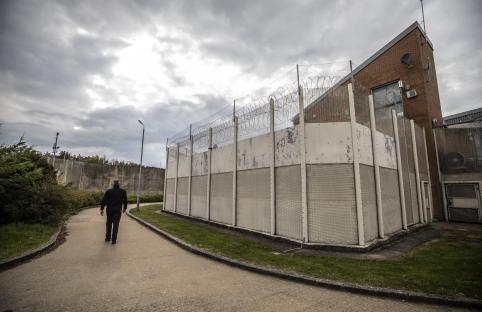 Prison officer walking near a separation unit at Woodhill prison.