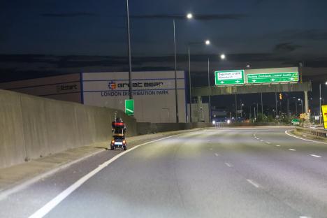 Mobility scooter on A13 highway at night.