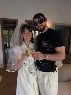 Couple celebrating an engagement, toasting with champagne.