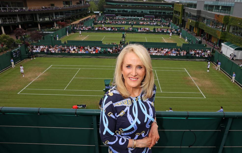 Tracy Austin at Wimbledon, with tennis courts in the background.