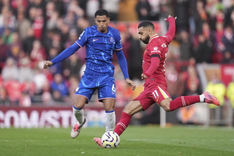 Mohamed Salah kicking the ball during a soccer match.