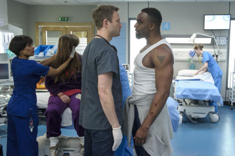 Scene from Casualty showing several characters in a hospital room.