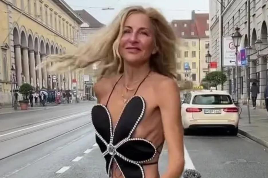 Woman shocks in extremely skimpy two-piece outfit & stunning long legs – but you’ll never guess her age cover image