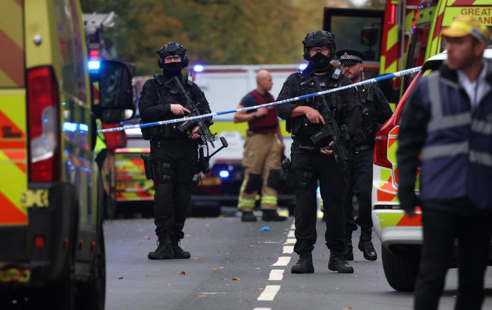 Armed police officers and emergency personnel at the scene of an attack in north Manchester.