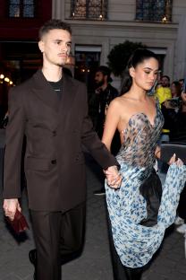Romeo Beckham and Kim Turnbull holding hands at Paris Fashion Week.